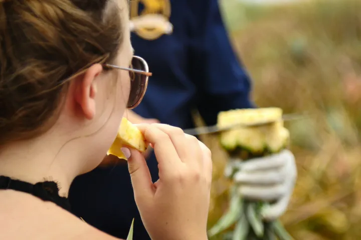 a woman eating a hot dog